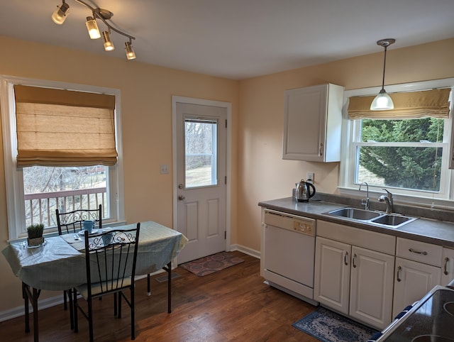 kitchen featuring sink, decorative light fixtures, white dishwasher, a healthy amount of sunlight, and white cabinets