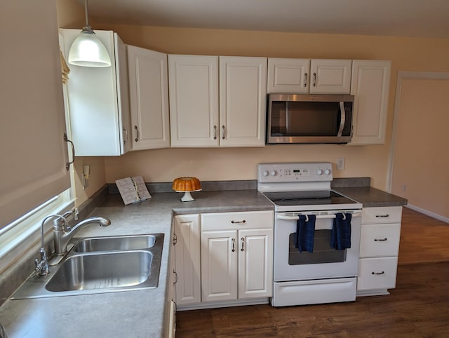 kitchen with white cabinets, sink, and electric range