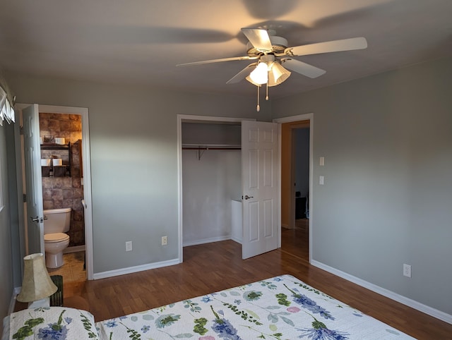 bedroom with connected bathroom, hardwood / wood-style flooring, a closet, and ceiling fan