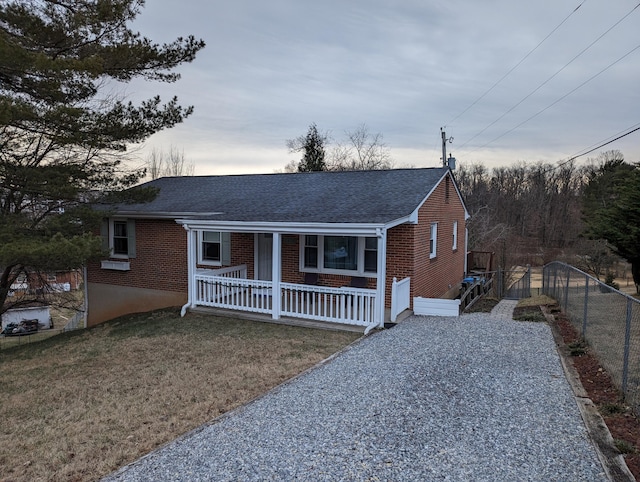 view of front of property with covered porch and a front lawn