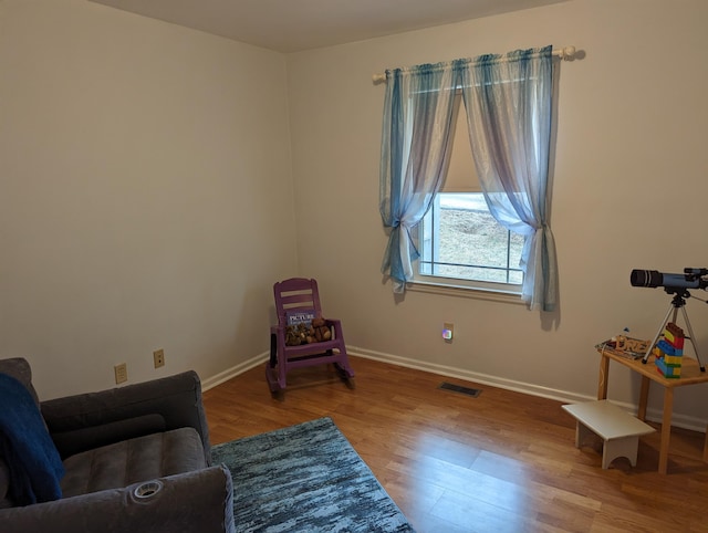 sitting room with hardwood / wood-style floors