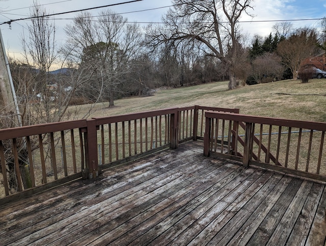 wooden terrace featuring a yard