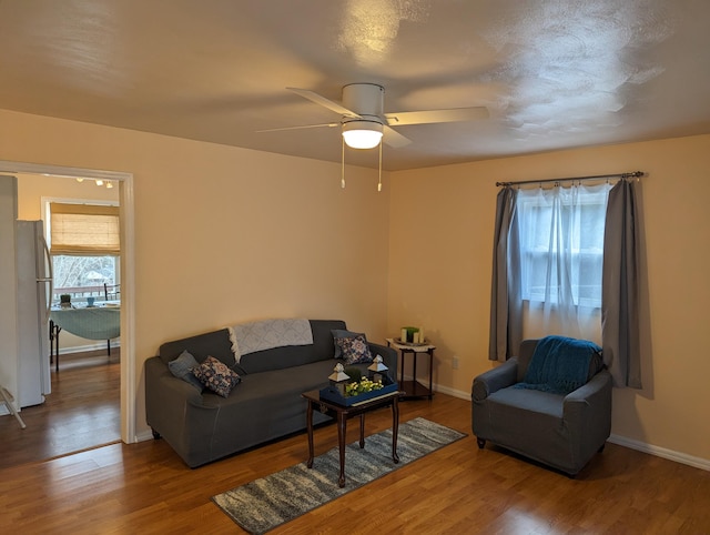 living room featuring hardwood / wood-style floors, plenty of natural light, and ceiling fan