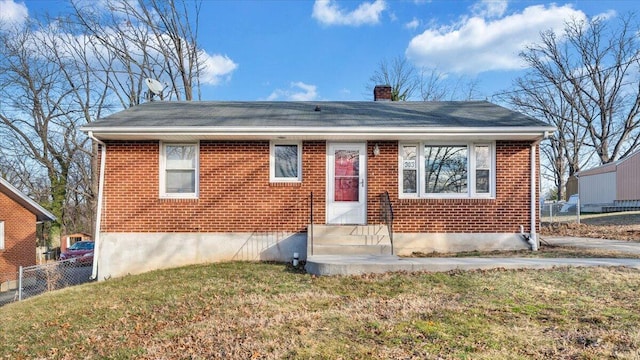 bungalow-style home featuring a front lawn