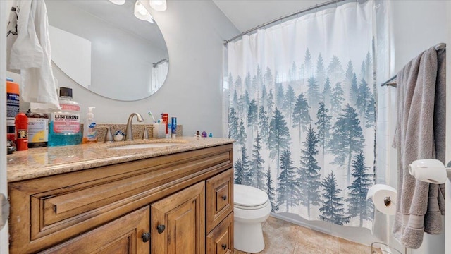 bathroom featuring tile patterned flooring, vanity, curtained shower, and toilet