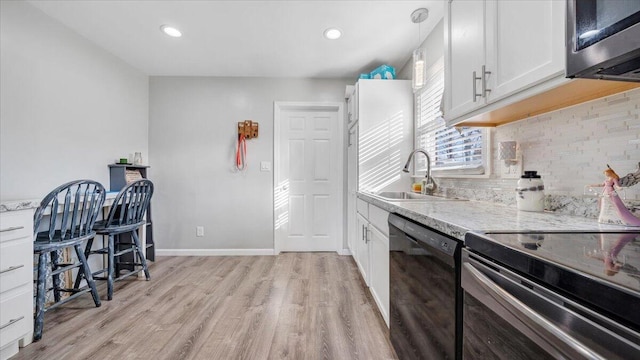 kitchen with pendant lighting, sink, dishwasher, white cabinetry, and electric range oven