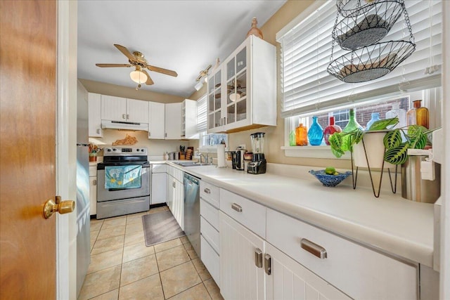 kitchen with white cabinetry, stainless steel appliances, sink, and light tile patterned floors