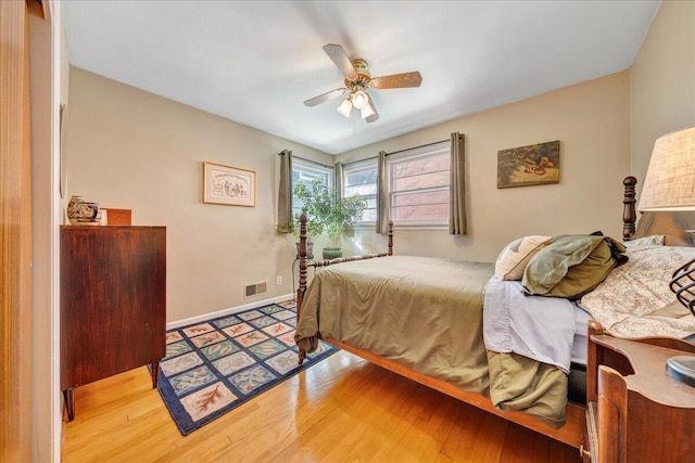 bedroom with ceiling fan and hardwood / wood-style floors