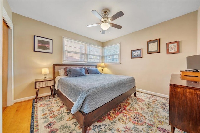 bedroom with light hardwood / wood-style floors, a closet, and ceiling fan