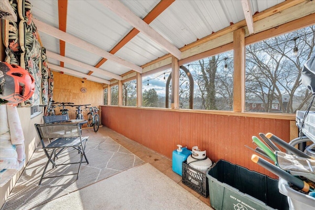 sunroom with vaulted ceiling with beams