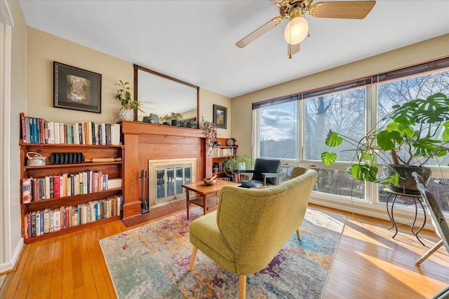 living area featuring ceiling fan and light wood-type flooring