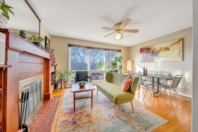 living room featuring ceiling fan and wood-type flooring