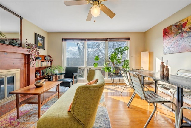 sitting room featuring ceiling fan and light wood-type flooring