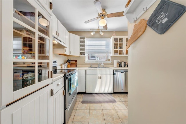 kitchen with white cabinetry, appliances with stainless steel finishes, sink, and light tile patterned floors