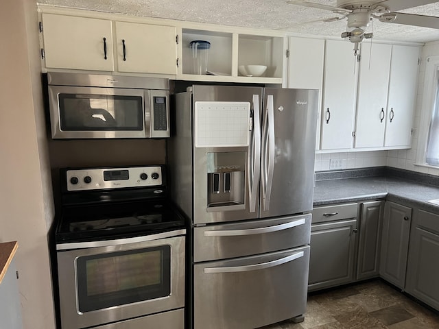 kitchen with white cabinetry, ceiling fan, stainless steel appliances, and gray cabinetry