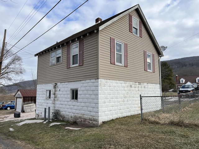 view of side of home featuring a lawn