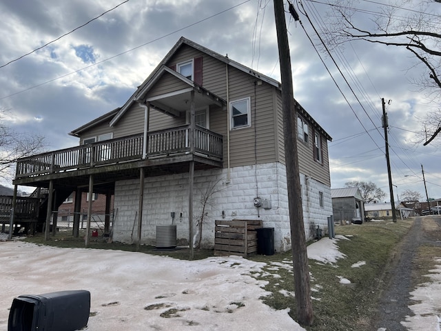 rear view of property featuring central AC and a deck