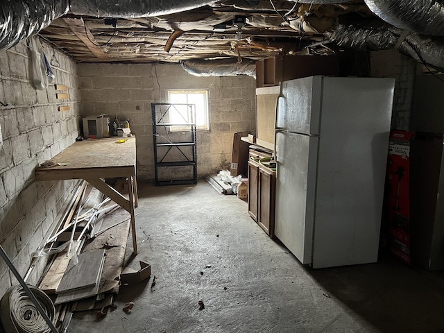 basement featuring white refrigerator