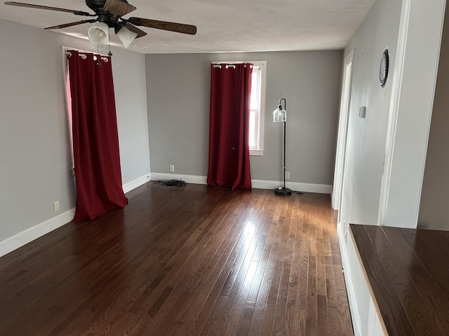 spare room with ceiling fan and dark hardwood / wood-style flooring