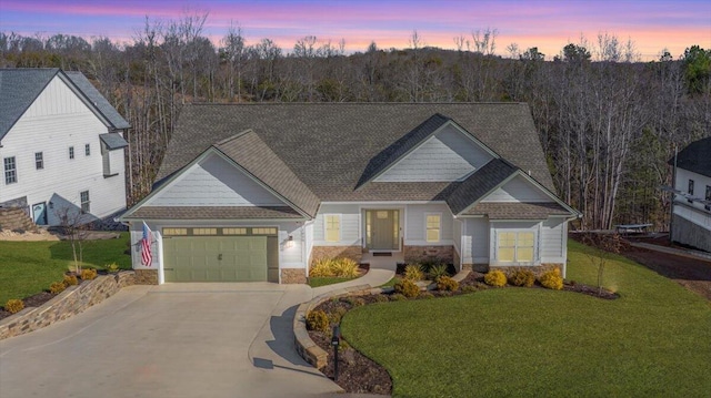 craftsman house with a yard and a garage