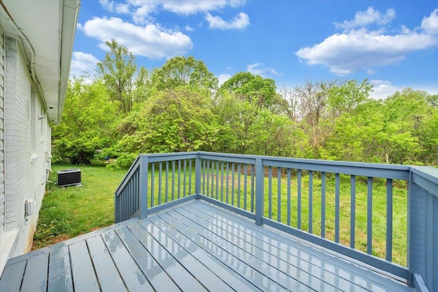 deck featuring central air condition unit and a yard