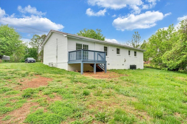 back of property with stairway, a wooden deck, a lawn, and cooling unit