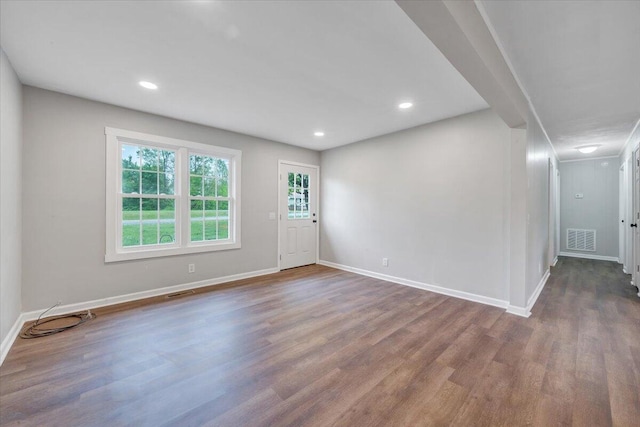 interior space featuring baseboards, wood finished floors, visible vents, and recessed lighting