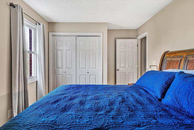 bedroom with a closet and a textured ceiling