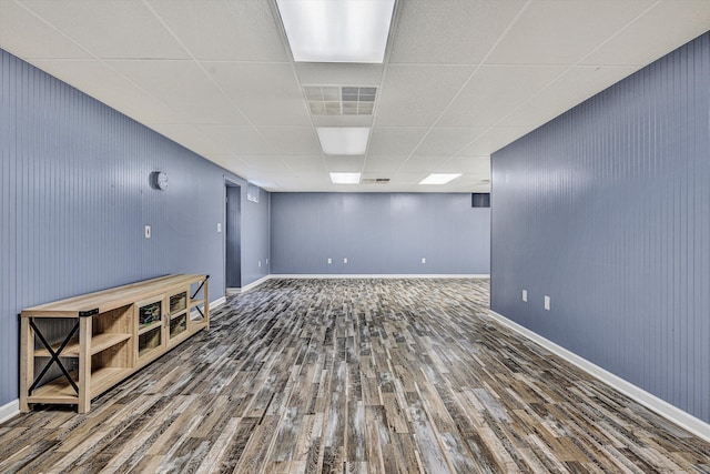 basement featuring a drop ceiling and hardwood / wood-style floors