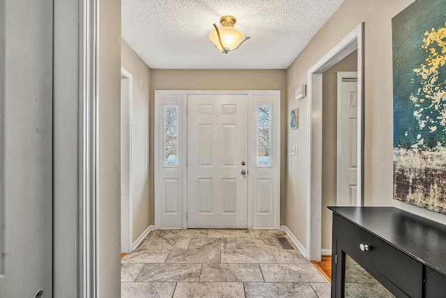 entrance foyer with a textured ceiling