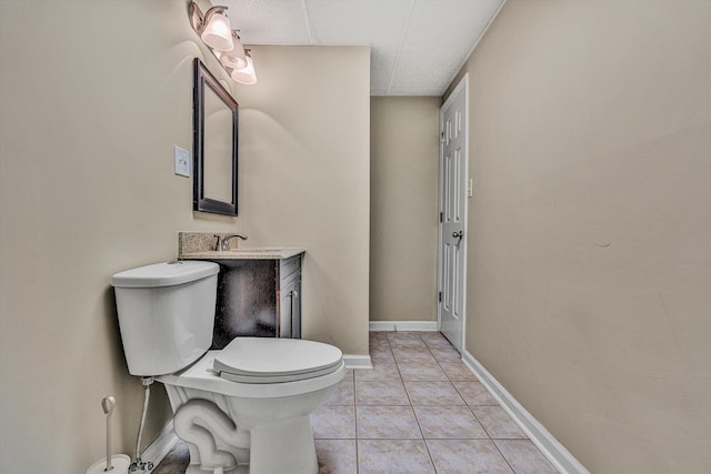 bathroom featuring vanity, toilet, and tile patterned flooring