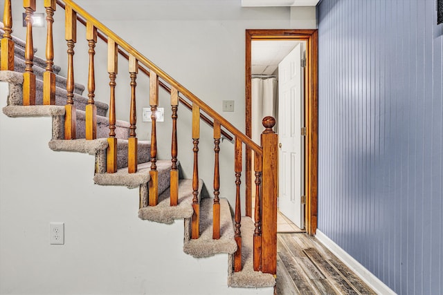 staircase with wood-type flooring