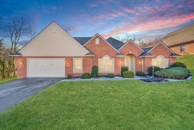 view of front of house featuring a garage and a yard