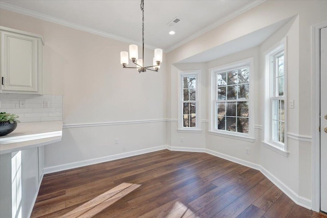 unfurnished dining area featuring ornamental molding, dark hardwood / wood-style flooring, and a notable chandelier