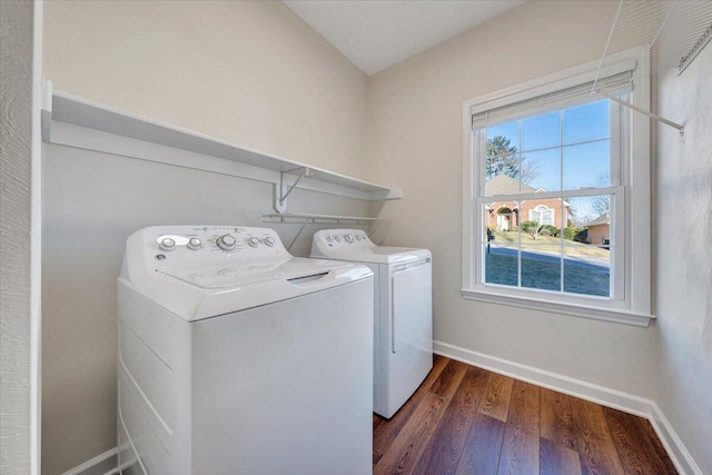 laundry room featuring dark wood-type flooring and washer and dryer