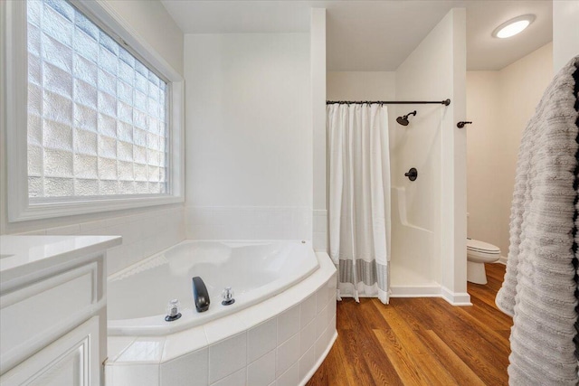 full bathroom featuring vanity, wood-type flooring, toilet, and separate shower and tub