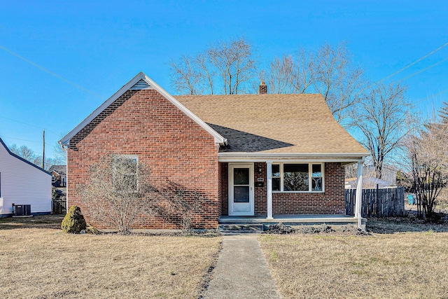 view of front of property featuring central AC unit, a front yard, and a porch