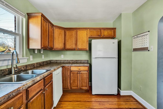 kitchen featuring sink, white appliances, and dark hardwood / wood-style floors