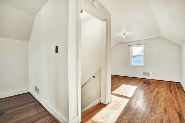 bonus room with lofted ceiling and hardwood / wood-style floors