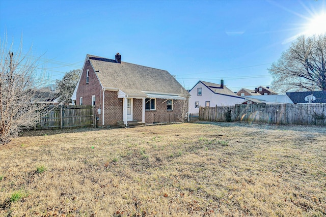 back of house with a yard