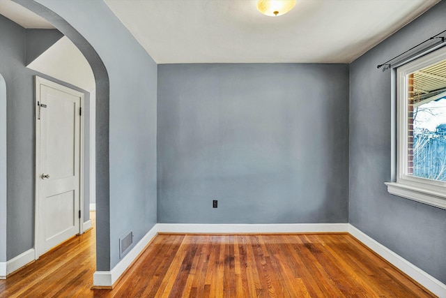 spare room featuring wood-type flooring