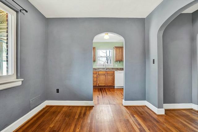 unfurnished room with sink and dark wood-type flooring