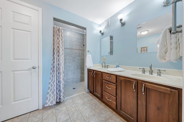 bathroom featuring tile patterned flooring, vanity, and walk in shower