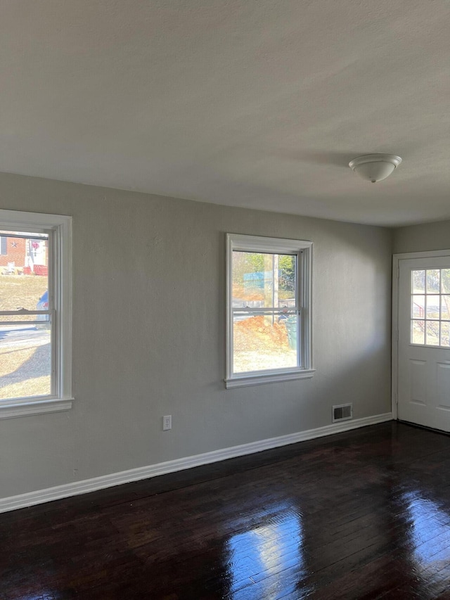 spare room with dark hardwood / wood-style floors