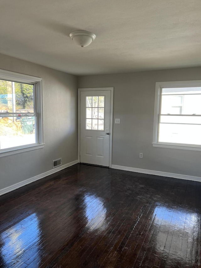 spare room with dark wood-type flooring