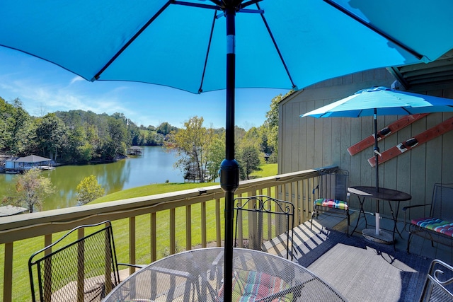 wooden deck featuring a yard and a water view