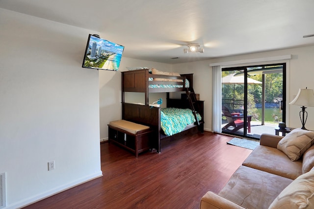 bedroom with access to outside and dark hardwood / wood-style flooring