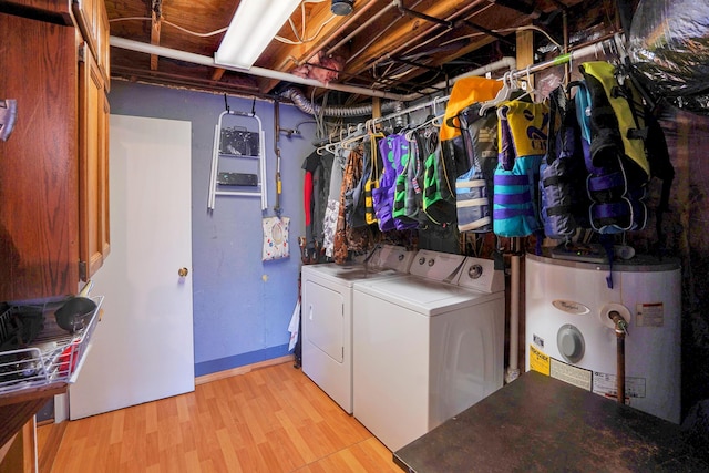 washroom with water heater, separate washer and dryer, and light hardwood / wood-style floors