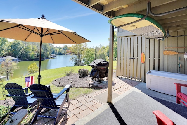 view of patio featuring a water view and a grill