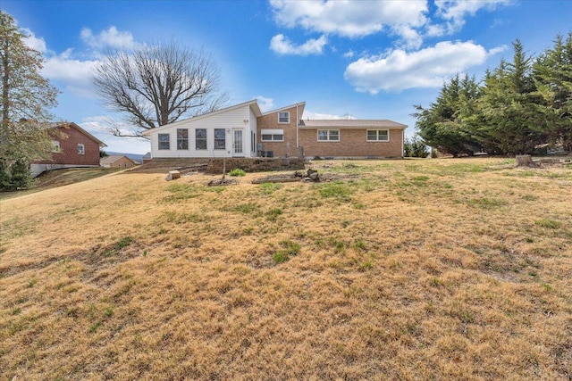 rear view of property with a yard